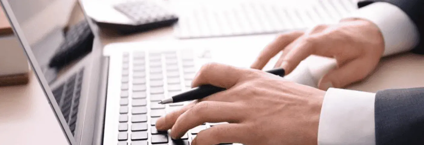 Person analyzing financial data on a laptop for card brand agreementoptimization.
